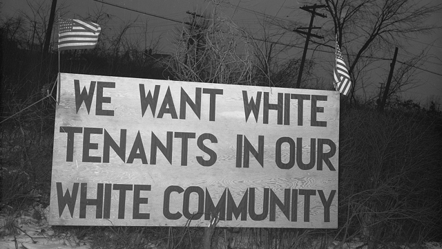 Detroit, Michigan. Riot at the Sojourner Truth homes, a new U.S federal
housing project, caused by white neighbors' attempt to prevent Negro tenants
from moving in. Sign with American flag "We want white tenants in our white
community," directly opposite the housing project. Credit: Library of Congress.